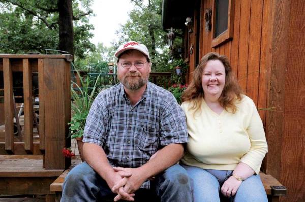 Kerri and her husband, Dale, on the deck of their Little House in the Big Woods.